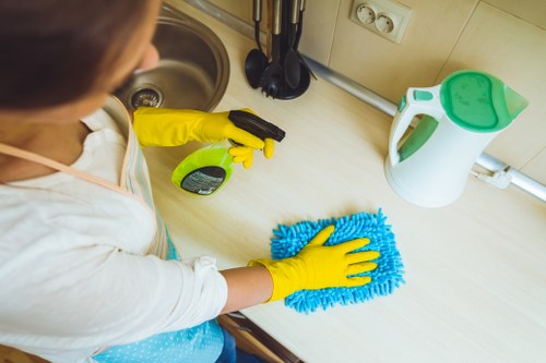 Cleaner treating a fabric armchair during upholstery cleaning